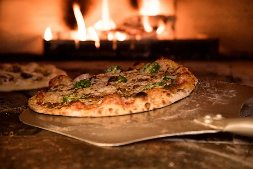 Pizza baking in a wood-fired oven