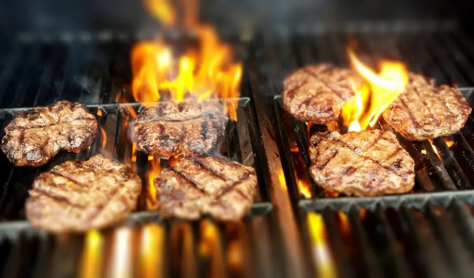 Burgers on a flaming grill