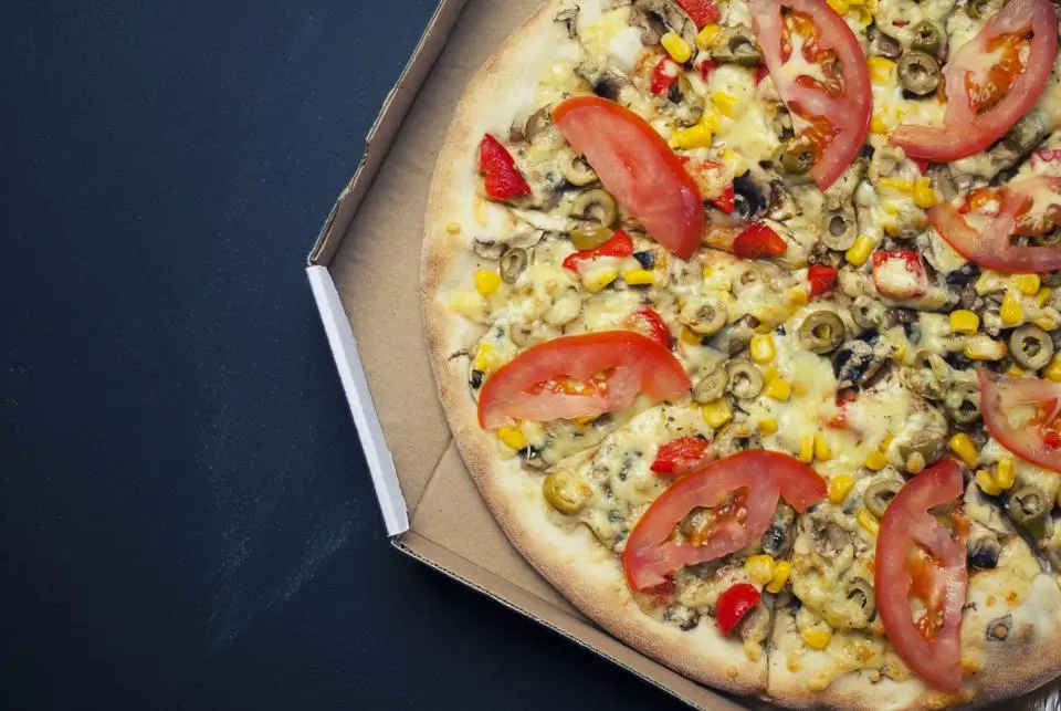 Vegetable pizza in a takeaway box